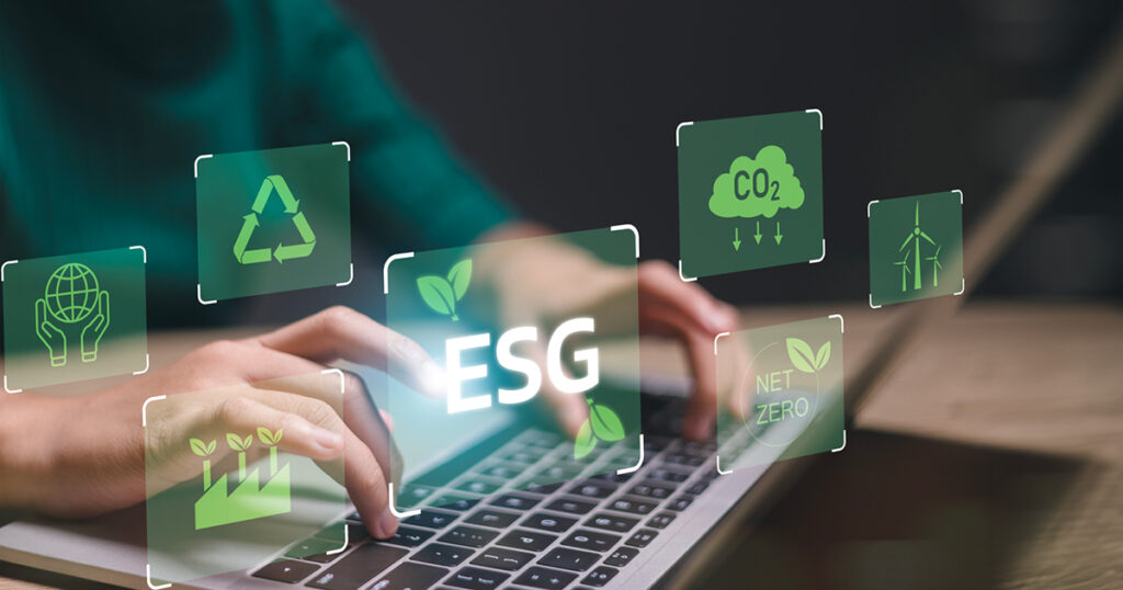 Ruke na tastaturi laptopa okružene ESG ikonama — reciklaža, net zero, CO₂, vetroturbina i društvena odgovornost