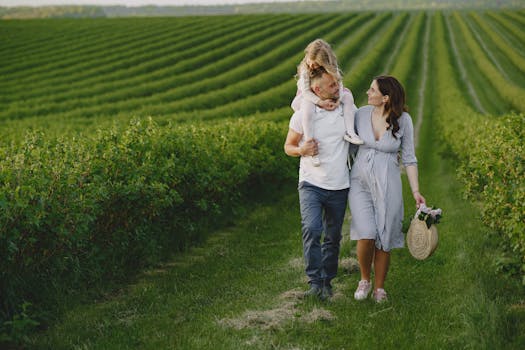 A joyful family strolls together in a beautiful green vineyard, capturing moments of love and togetherness.